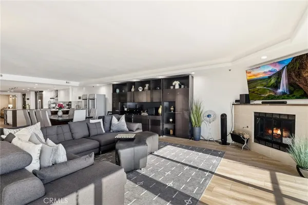 a living room with furniture a fireplace and a flat screen tv