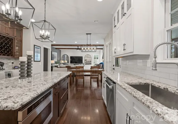 a kitchen with center island cabinets stainless steel appliances and a dining table