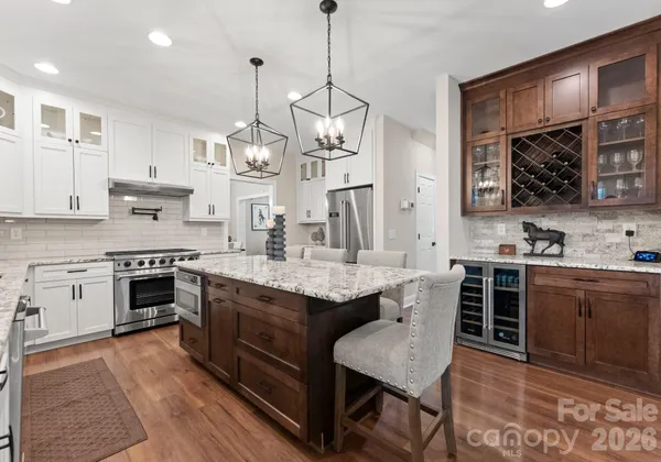 a kitchen with stainless steel appliances granite countertop a refrigerator and a stove