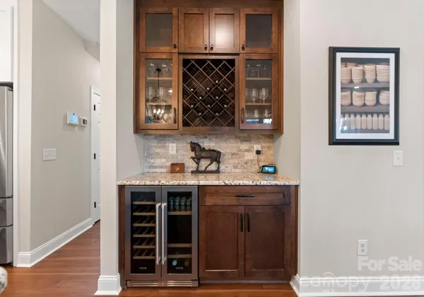 a living room with furniture a flat screen tv and a window