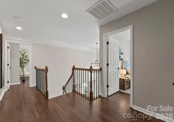 a bedroom with bed and a chandelier
