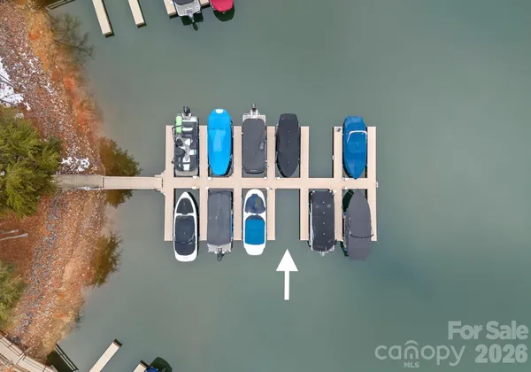 an aerial view of a house with swimming pool and sitting area