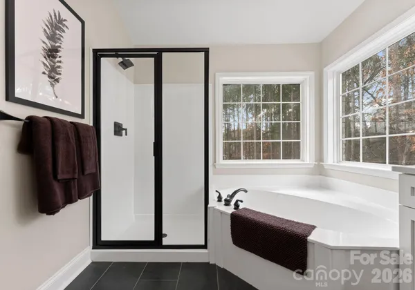 a bathroom with double vanity sink two mirror and a window