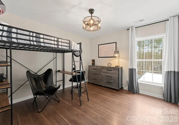a view of bedroom with furniture and windows