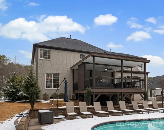an aerial view of a house with a swimming pool