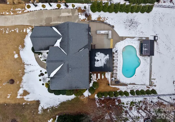 an aerial view of a house with a yard and lake view