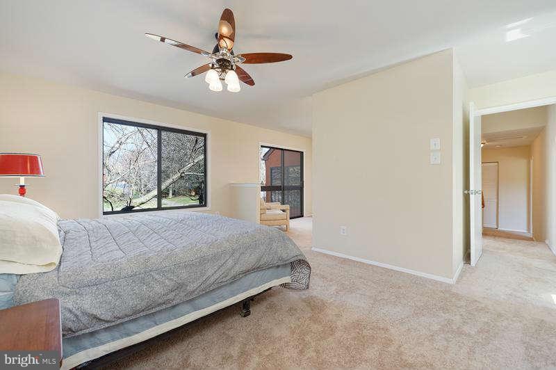 10907 Knights Bridge Court Reston, VA 20190 - Photo 11 of 24 a bedroom with a large bed and a window