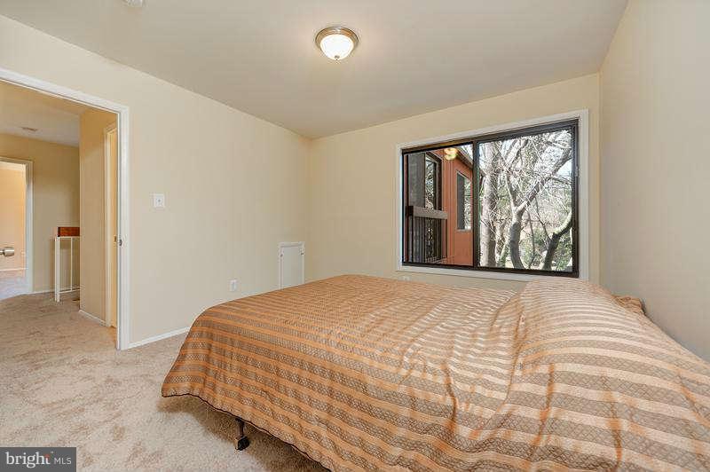 10907 Knights Bridge Court Reston, VA 20190 - Photo 15 of 24 a bedroom with a large bed and a large window