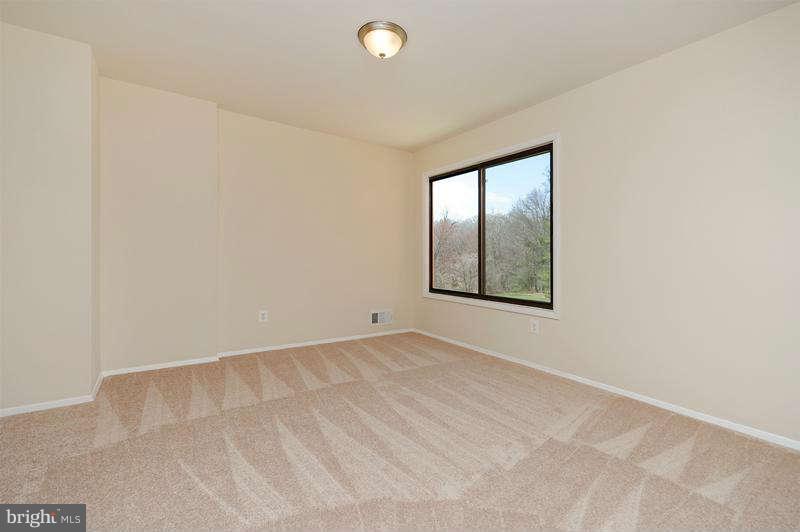 10907 Knights Bridge Court Reston, VA 20190 - Photo 16 of 24 an empty room with windows and closet