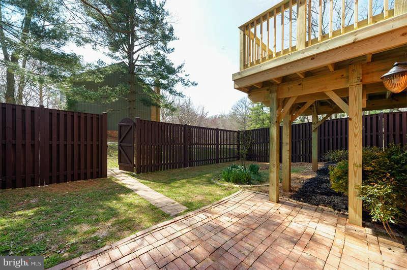10907 Knights Bridge Court Reston, VA 20190 - Photo 20 of 24 a view of backyard with small cabin and wooden fence