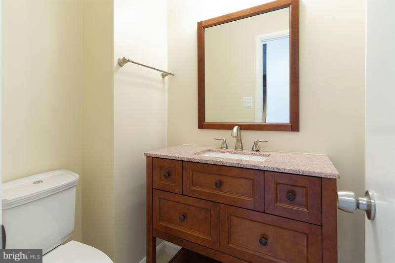 10907 Knights Bridge Court Reston, VA 20190 - Photo 9 of 24 a bathroom with a granite countertop toilet sink and mirror