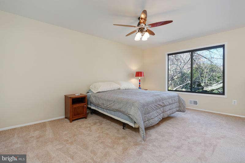 10907 Knights Bridge Court Reston, VA 20190 - Photo 10 of 24 a bedroom with a bed and a ceiling fan