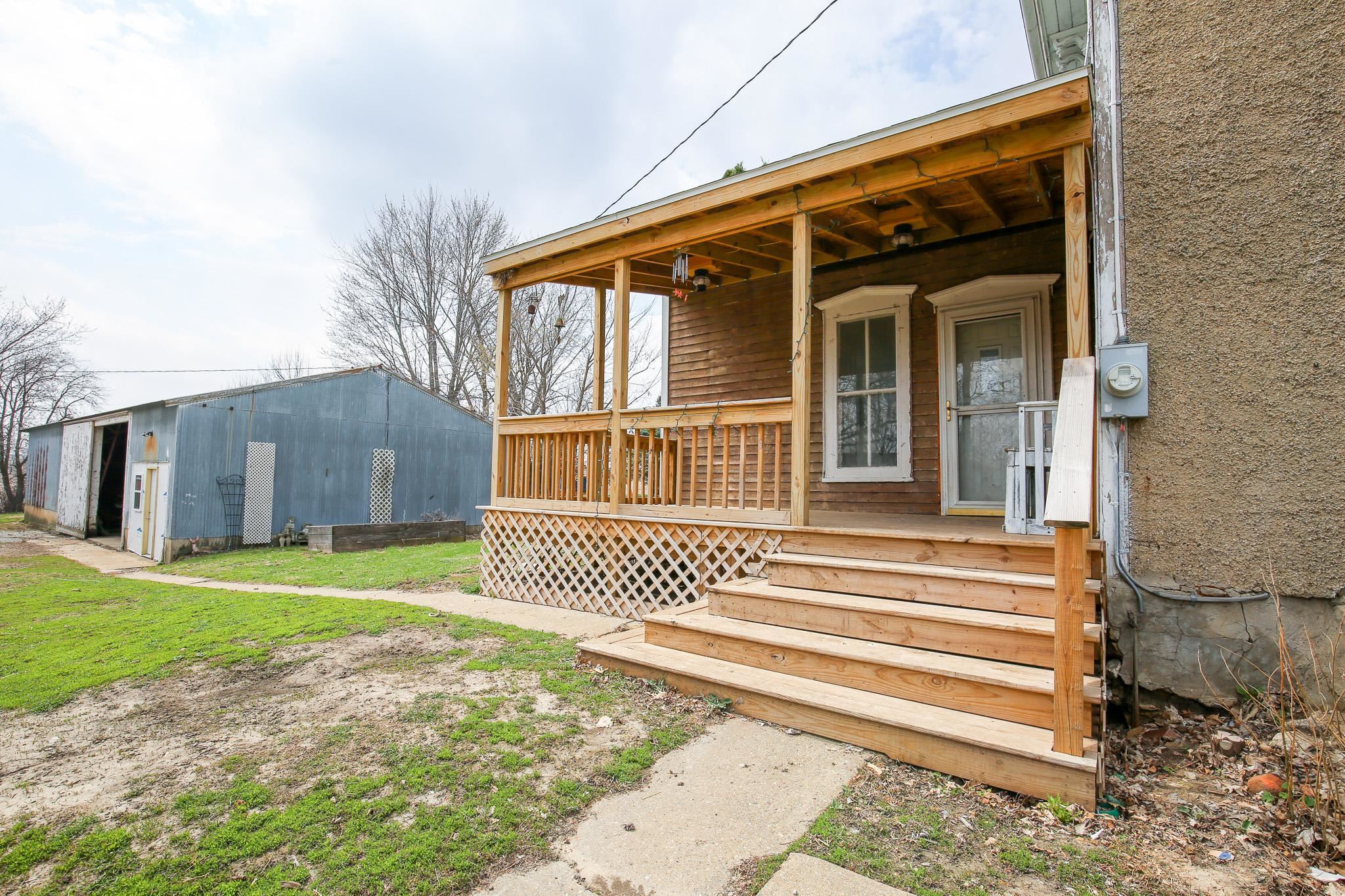 26596 Fairhaven Road Chadwick, IL 61014 - Photo 21 of 51 a front view of a house with a garden