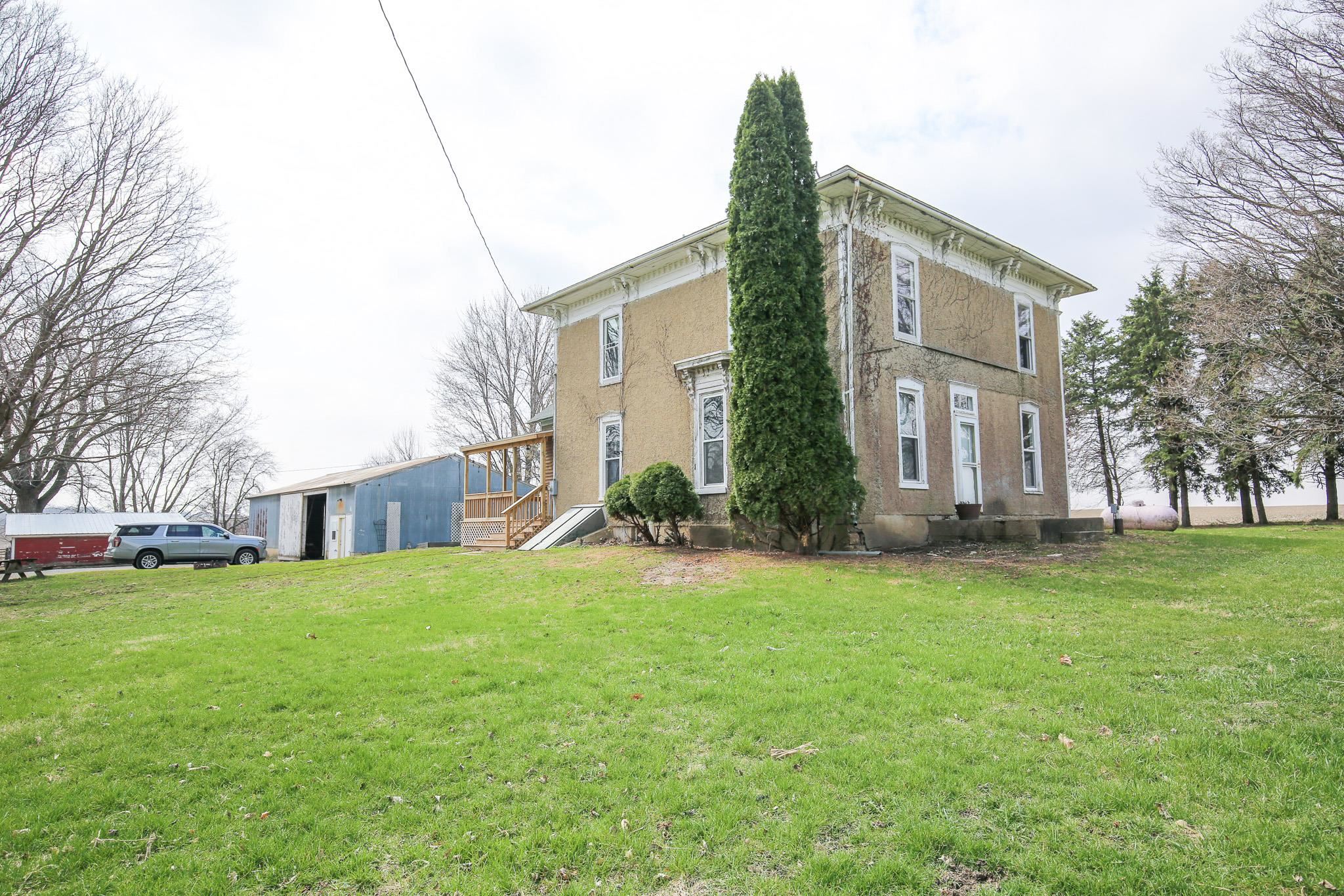 26596 Fairhaven Road Chadwick, IL 61014 - Photo 3 of 51 a view of a house with a big yard and large trees