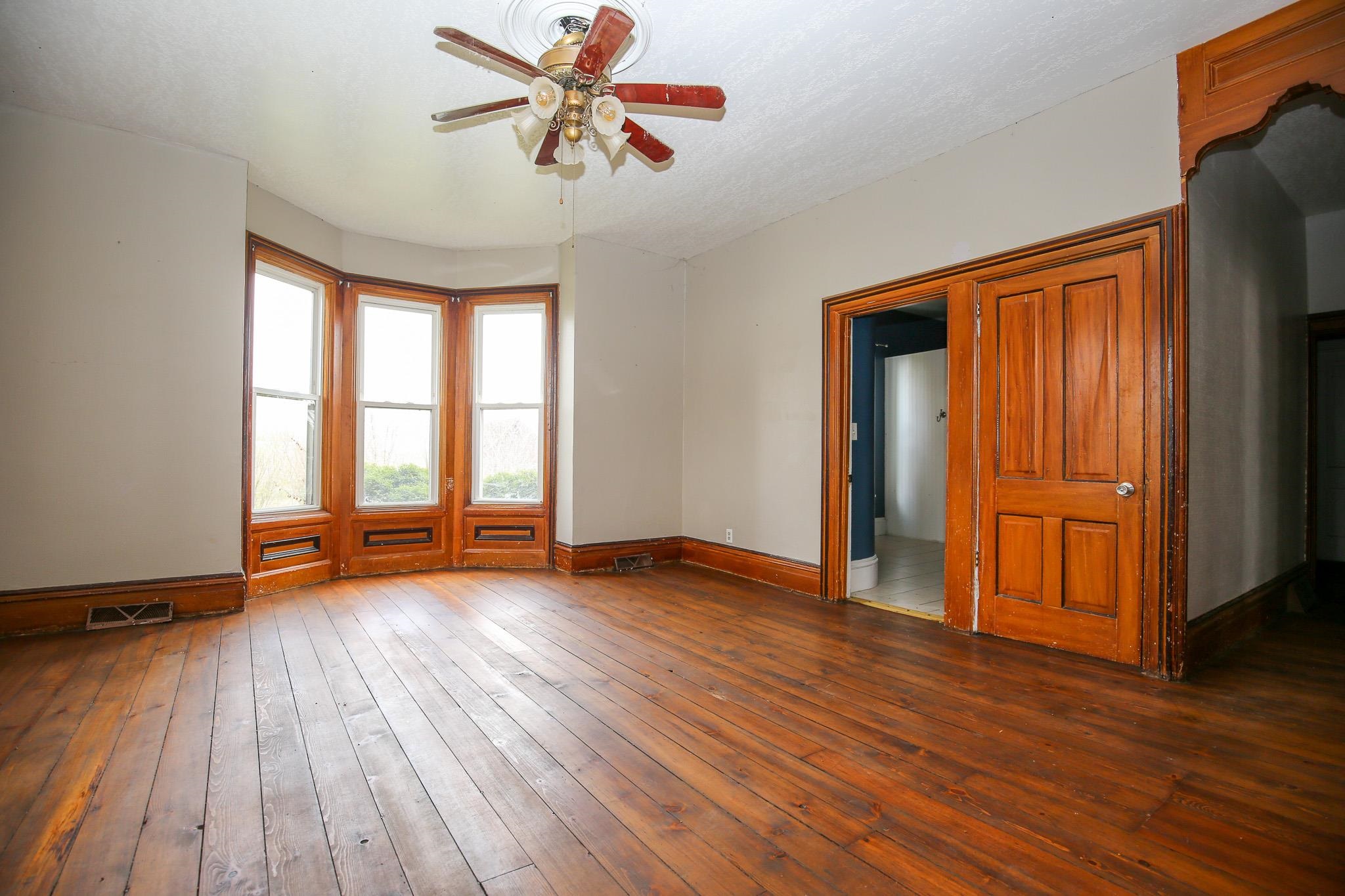 26596 Fairhaven Road Chadwick, IL 61014 - Photo 31 of 51 an empty room with wooden floor and windows