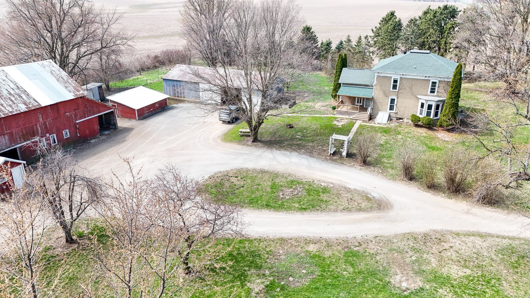26596 Fairhaven Road Chadwick, IL 61014 - Photo 46 of 51 a view of a backyard with table and chairs under an umbrella