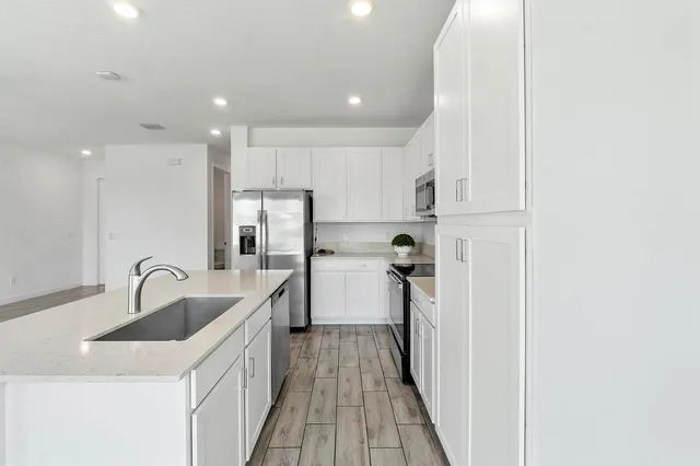 a kitchen with a sink and refrigerator