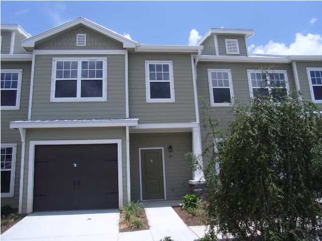 28 South Sand Palm Road, Unit 46 Freeport, FL 32439 - Photo 1 of 19 a front view of a house with a yard and garage