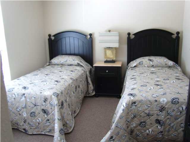 28 South Sand Palm Road, Unit 46 Freeport, FL 32439 - Photo 12 of 19 a bed sitting in a bedroom next to a bathroom sink