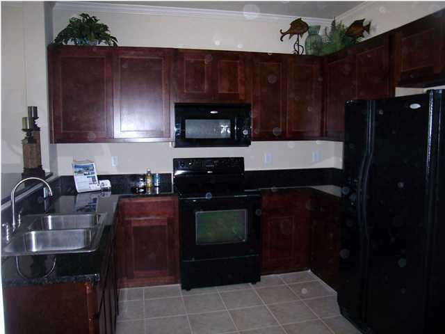 28 South Sand Palm Road, Unit 46 Freeport, FL 32439 - Photo 8 of 19 a kitchen with a sink a stove and cabinets
