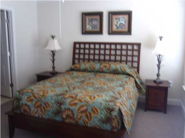 28 South Sand Palm Road, Unit 46 Freeport, FL 32439 - Photo 10 of 19 a bedroom with a bed and chair