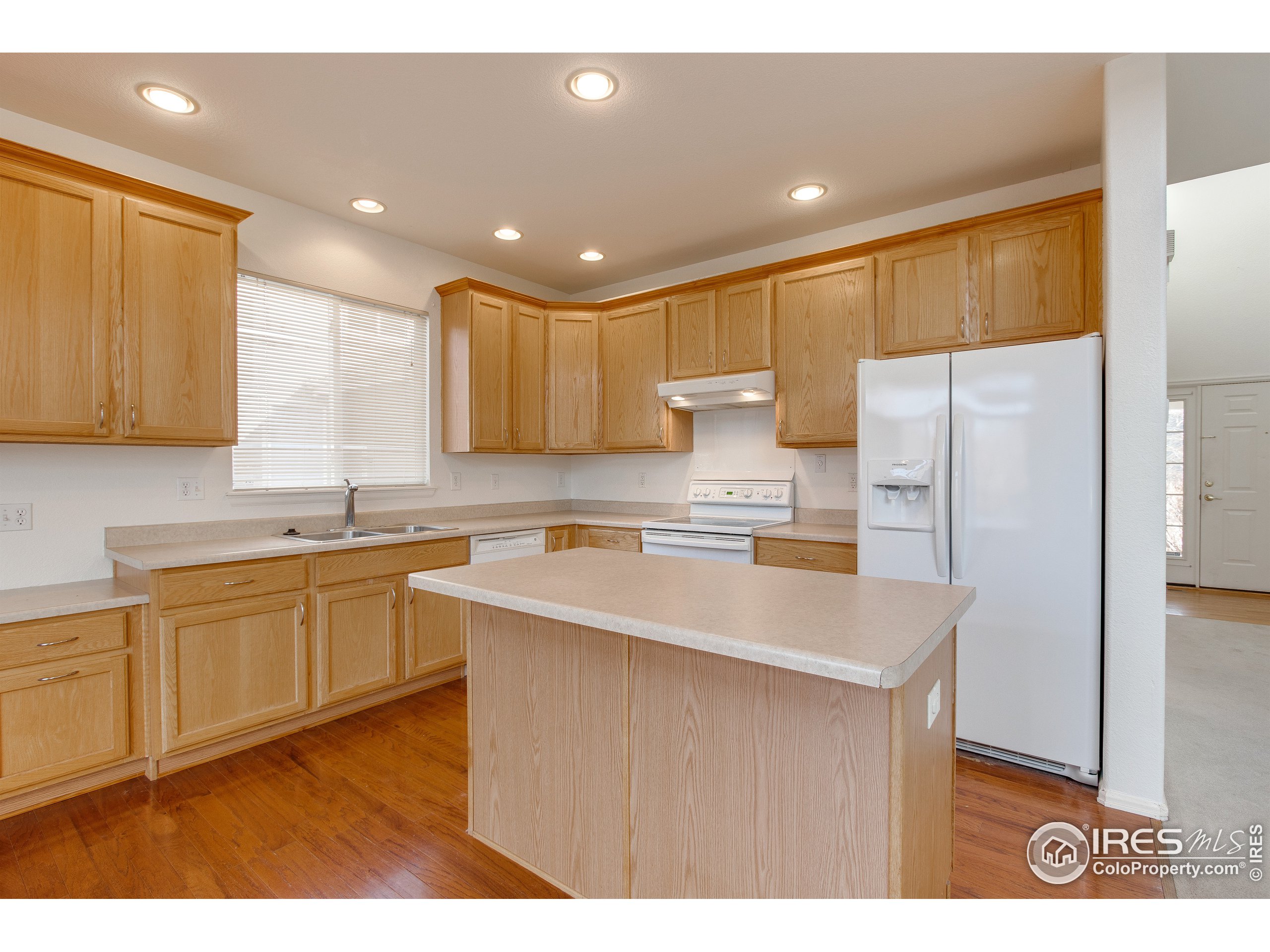 6808 Silverleaf Avenue Firestone, CO 80504 - Photo 11 of 40 a kitchen with kitchen island a sink stainless steel appliances and cabinets