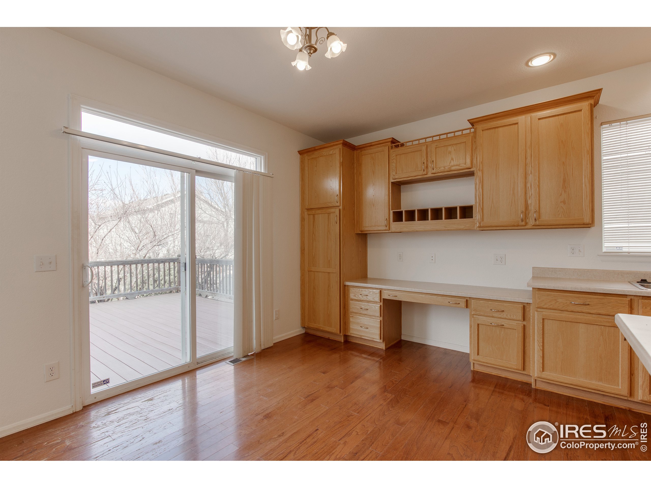 6808 Silverleaf Avenue Firestone, CO 80504 - Photo 15 of 40 a kitchen with stainless steel appliances granite countertop a stove a sink and a refrigerator with wooden floor