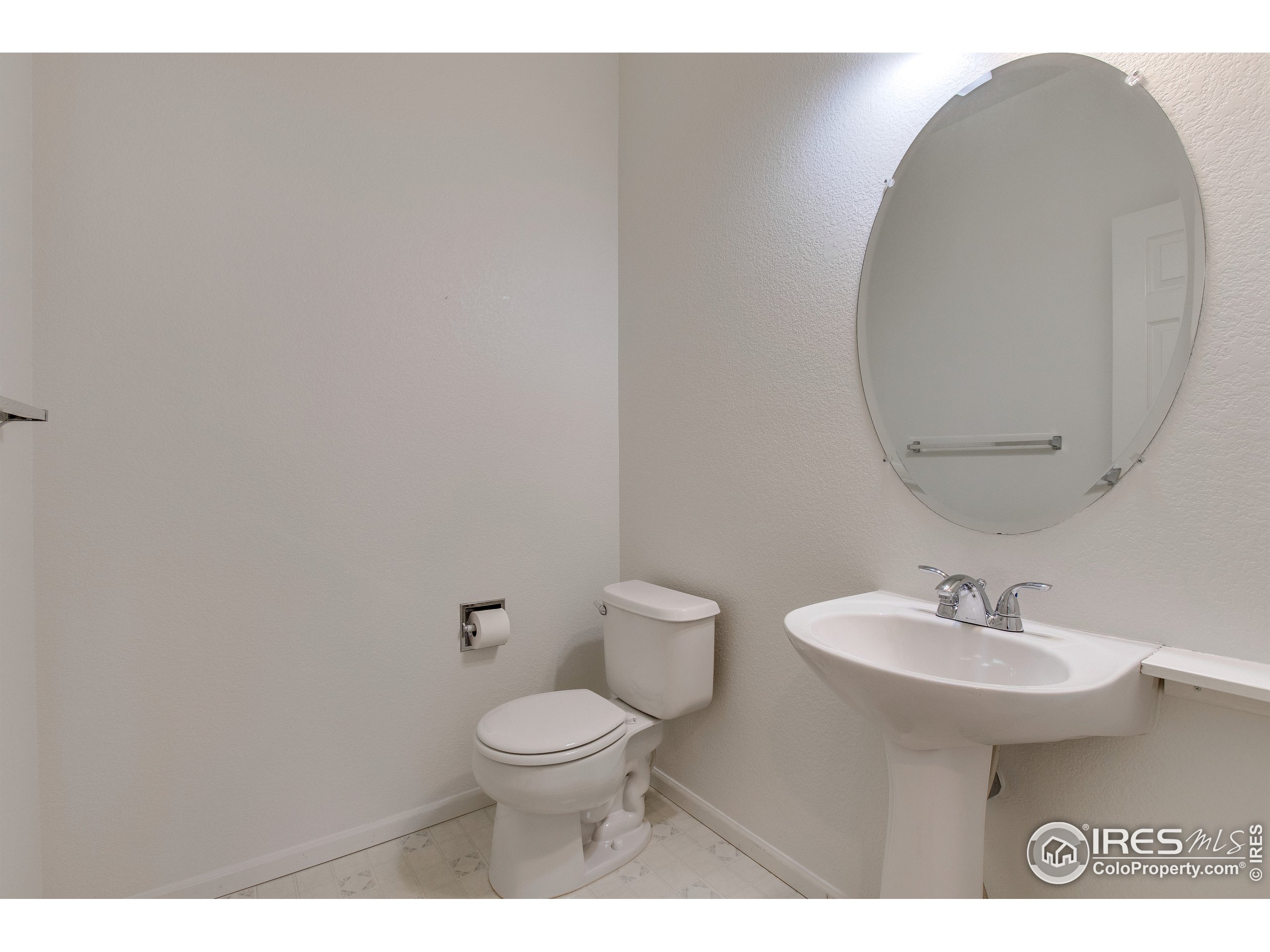 6808 Silverleaf Avenue Firestone, CO 80504 - Photo 19 of 40 a bathroom with a toilet a sink and mirror