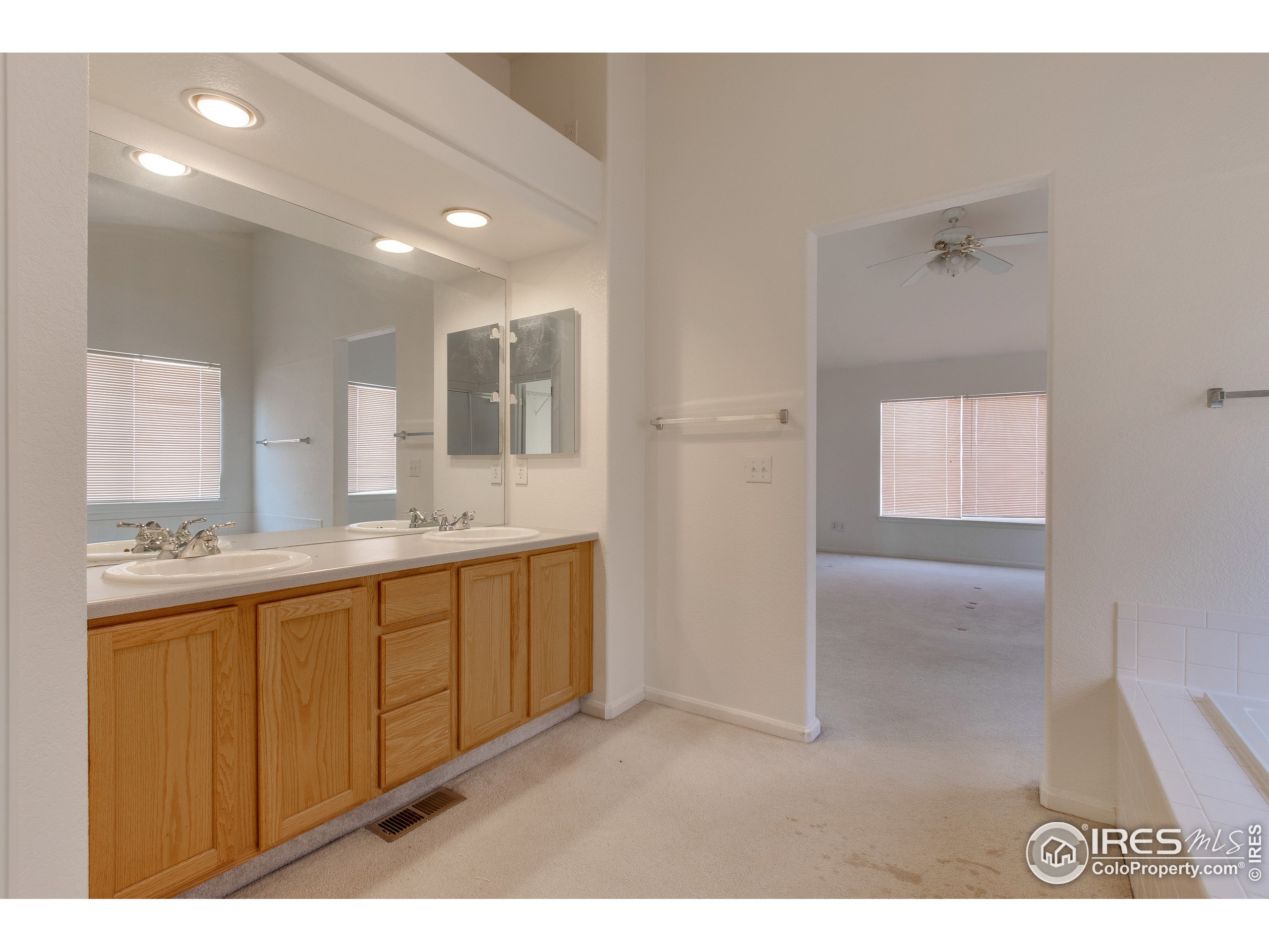 6808 Silverleaf Avenue Firestone, CO 80504 - Photo 22 of 40 a bathroom with a granite countertop sink mirror and double