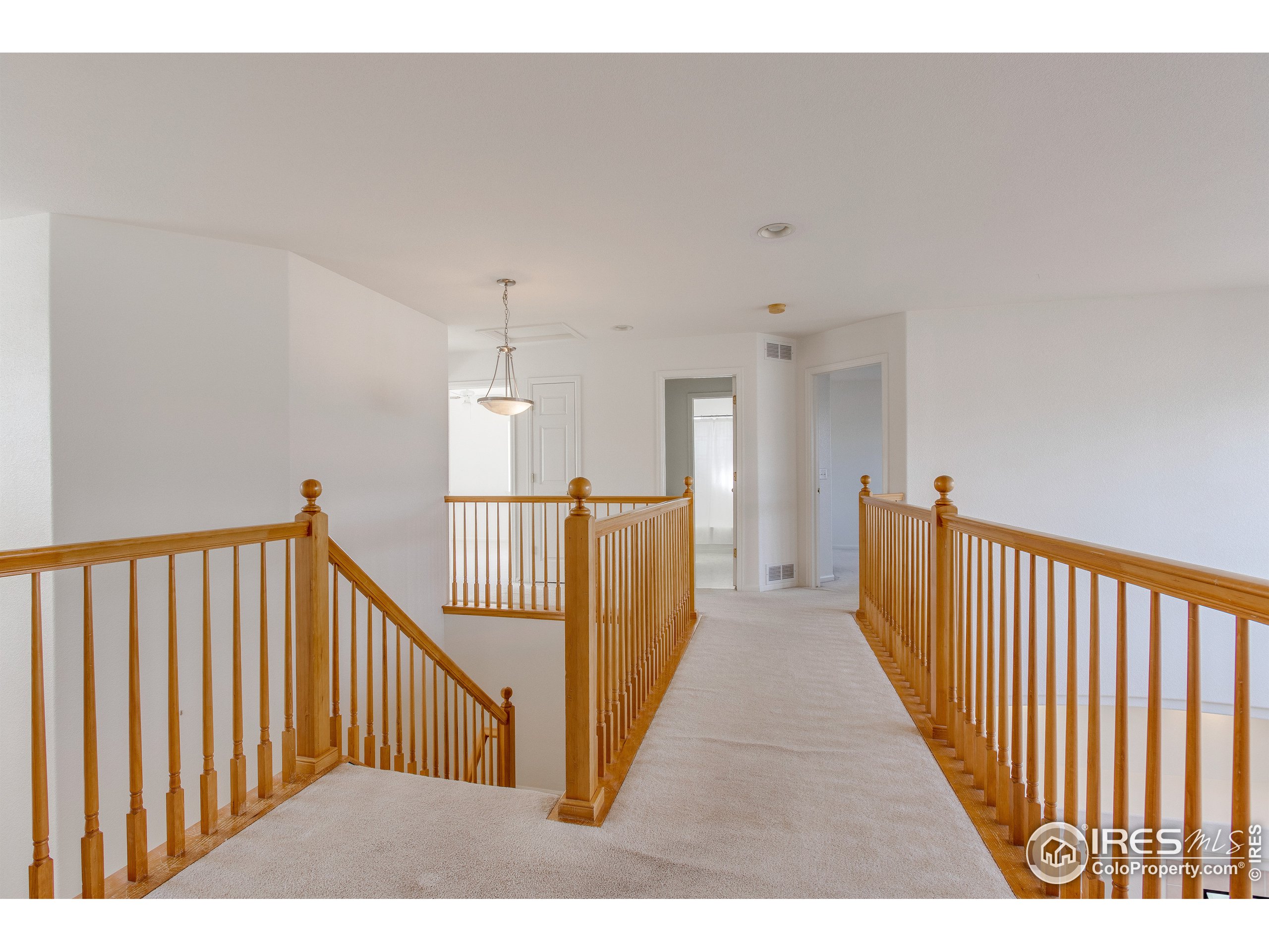 6808 Silverleaf Avenue Firestone, CO 80504 - Photo 28 of 40 a view of a hallway with wooden floor