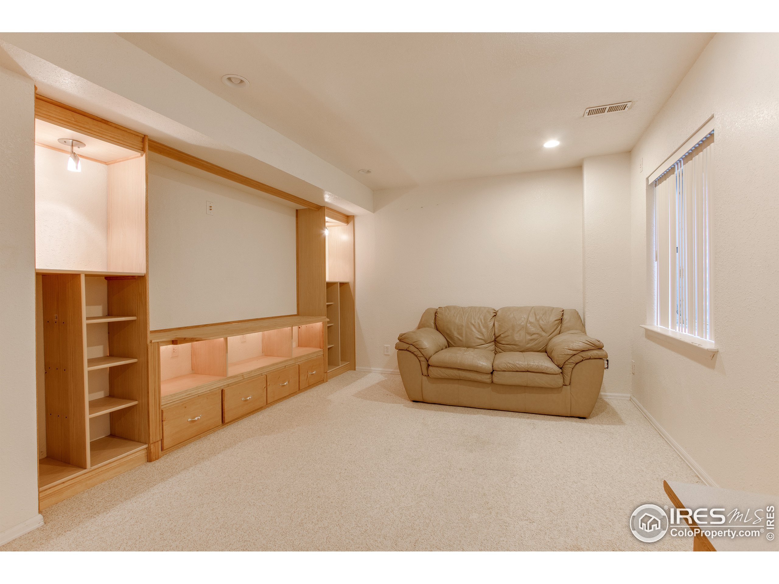 6808 Silverleaf Avenue Firestone, CO 80504 - Photo 34 of 40 a living room with furniture and a window