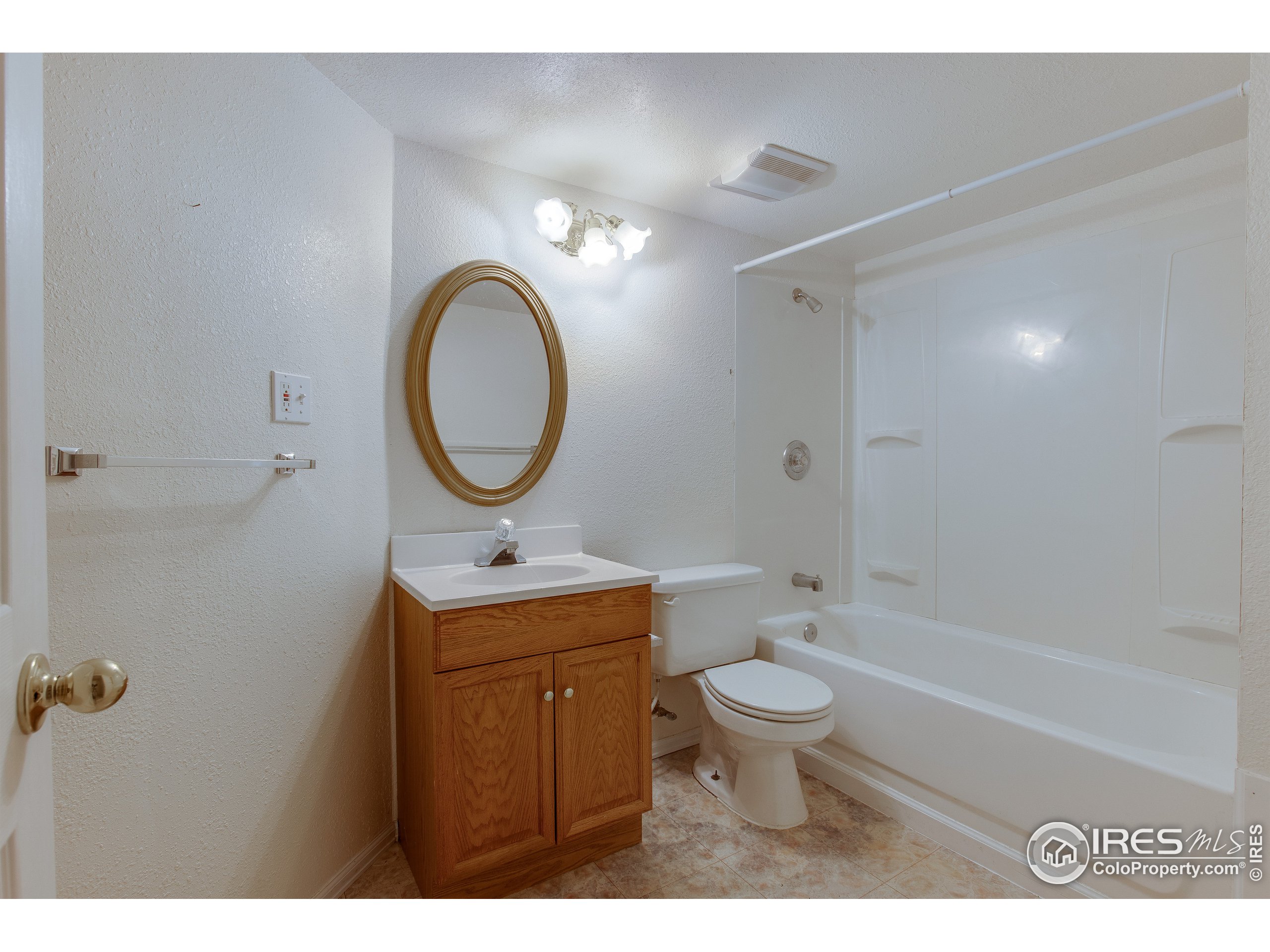 6808 Silverleaf Avenue Firestone, CO 80504 - Photo 38 of 40 a bathroom with a sink a toilet and a mirror