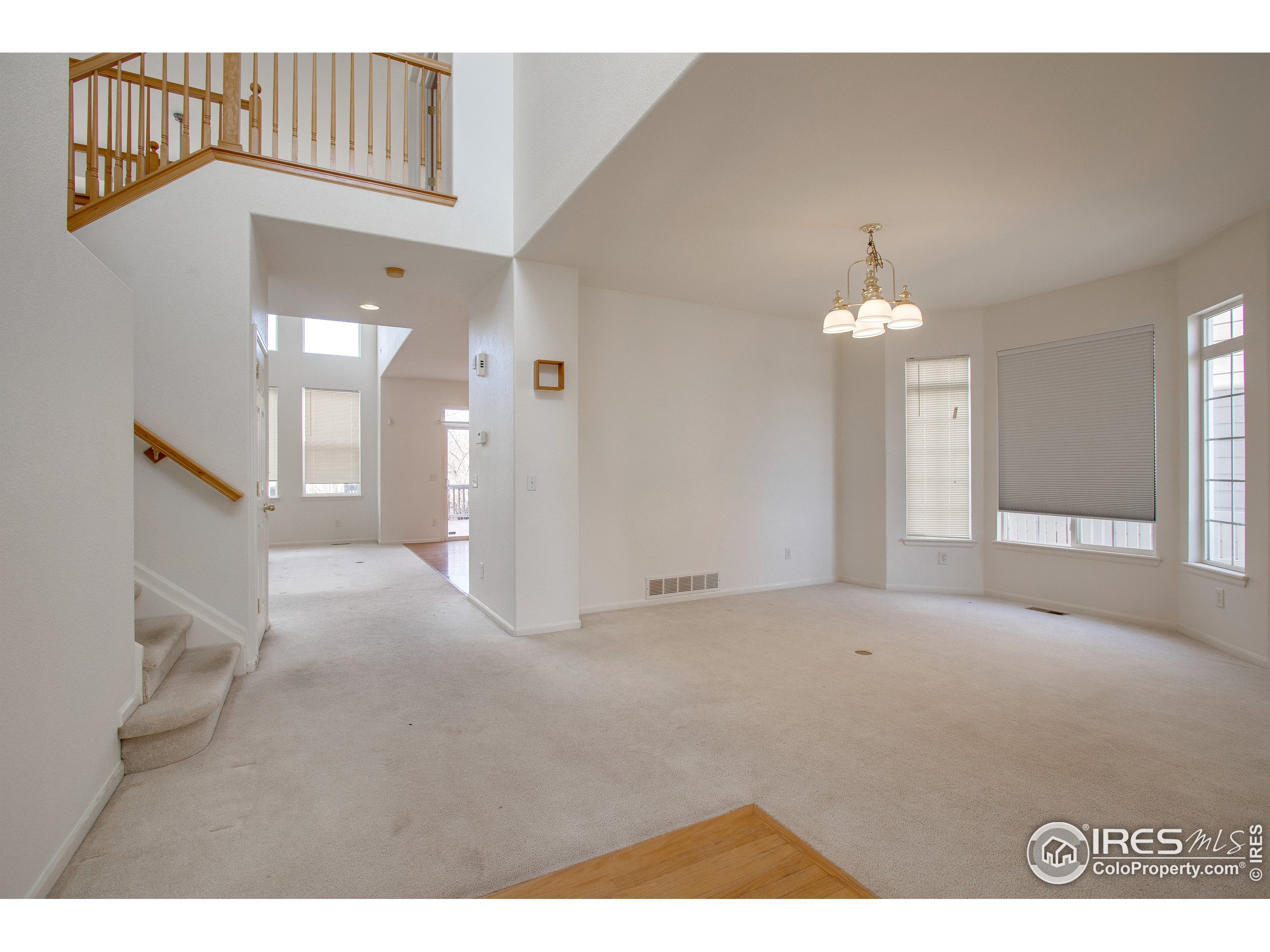 6808 Silverleaf Avenue Firestone, CO 80504 - Photo 7 of 40 a view of an empty room with chandelier and a window