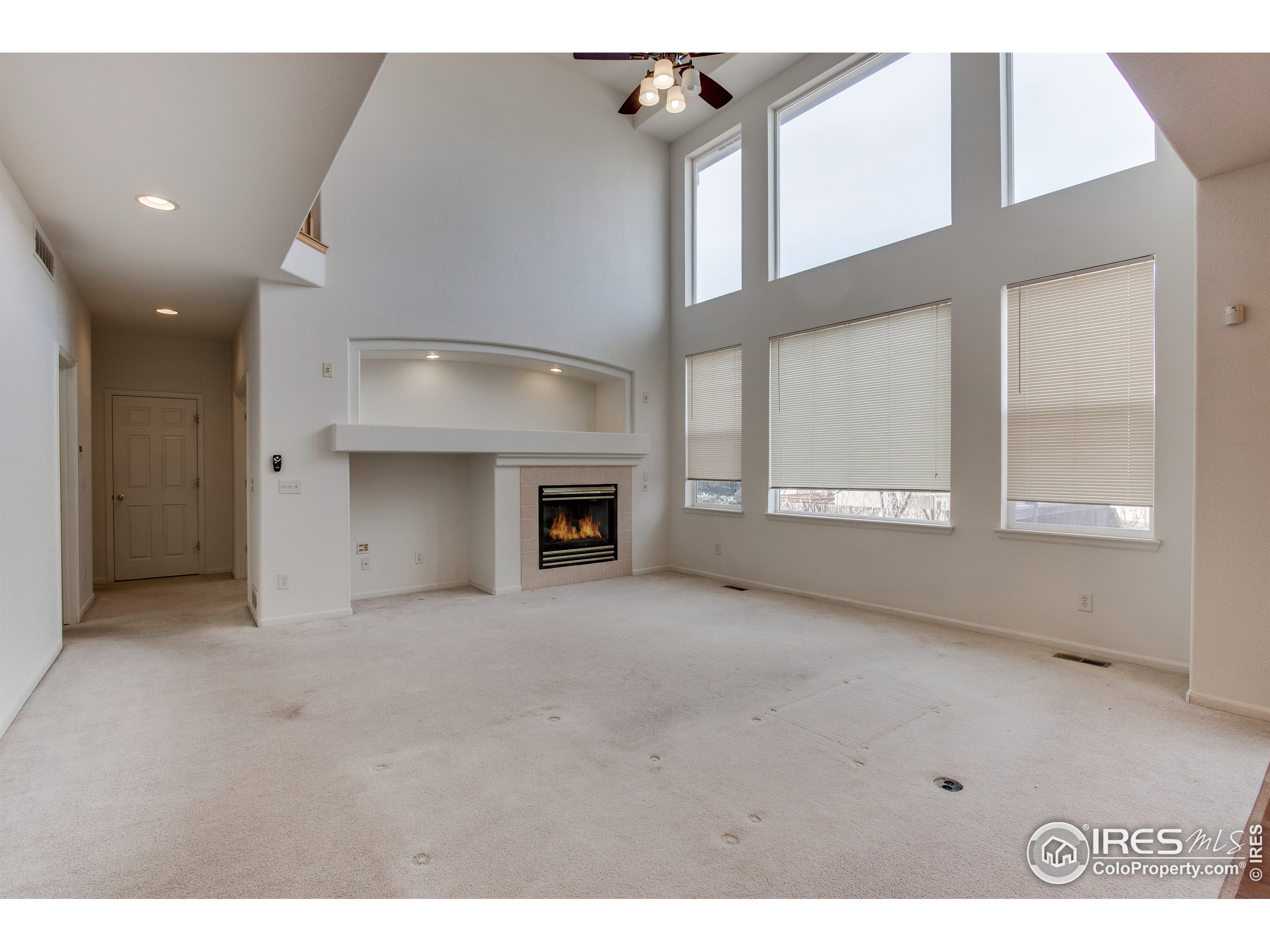 6808 Silverleaf Avenue Firestone, CO 80504 - Photo 8 of 40 a view of an empty room with a fireplace and a window