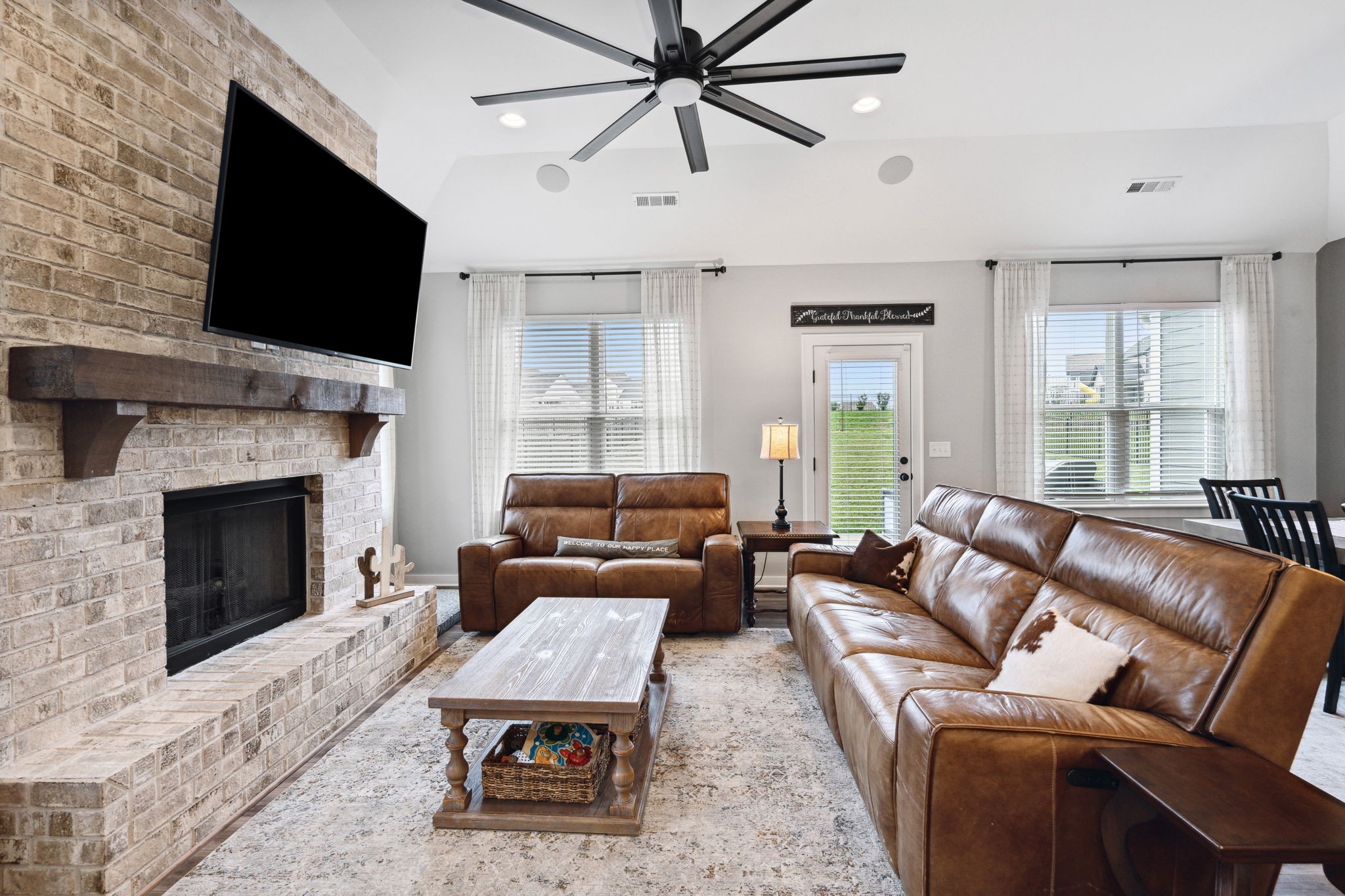 847 Plowson Road Mount Juliet, TN 37122 - Photo 11 of 56 a living room with furniture a fireplace and a flat screen tv