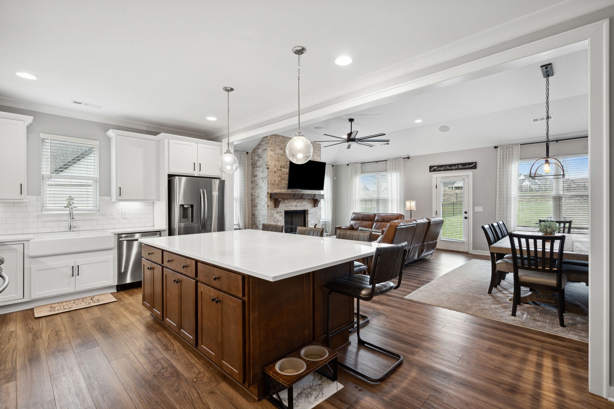 847 Plowson Road Mount Juliet, TN 37122 - Photo 9 of 56 a large kitchen with a table chairs and flat screen tv