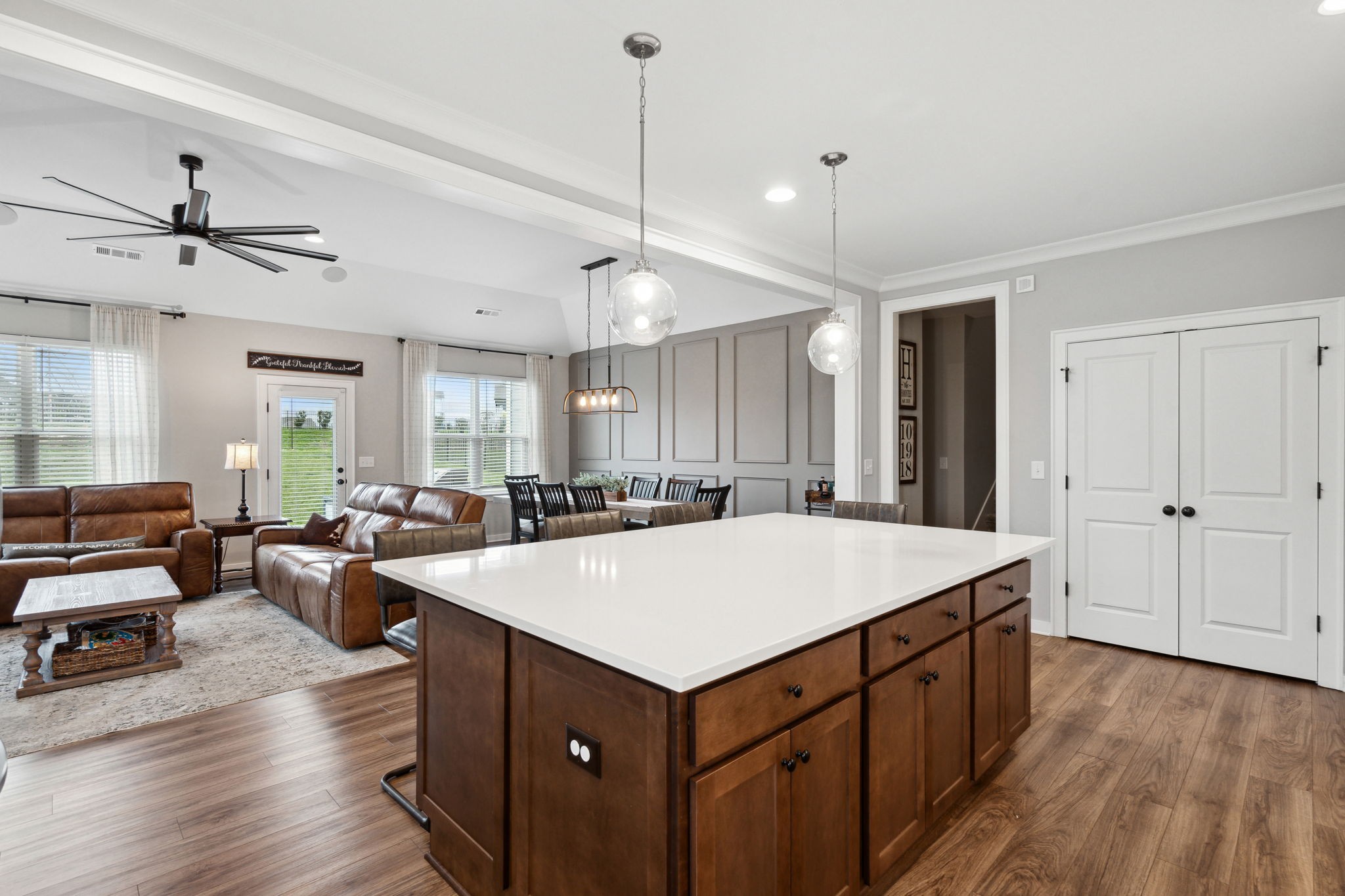 847 Plowson Road Mount Juliet, TN 37122 - Photo 10 of 56 a large kitchen with kitchen island a stove a sink dishwasher a dining table and chairs with wooden floor