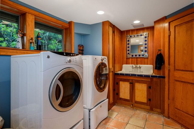 a view of a room with wooden floor and bench