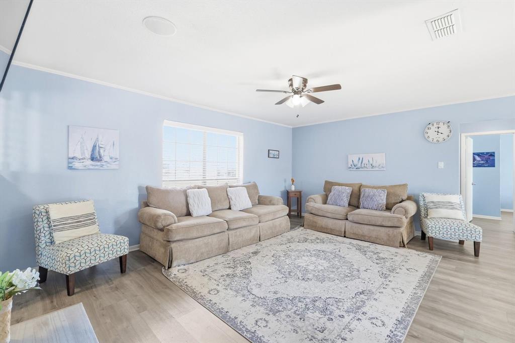 3873 Lois Road East Sanger, TX 76266 - Photo 14 of 40 Large furnished living space with ceiling fan, new flooring and plenty of space!
