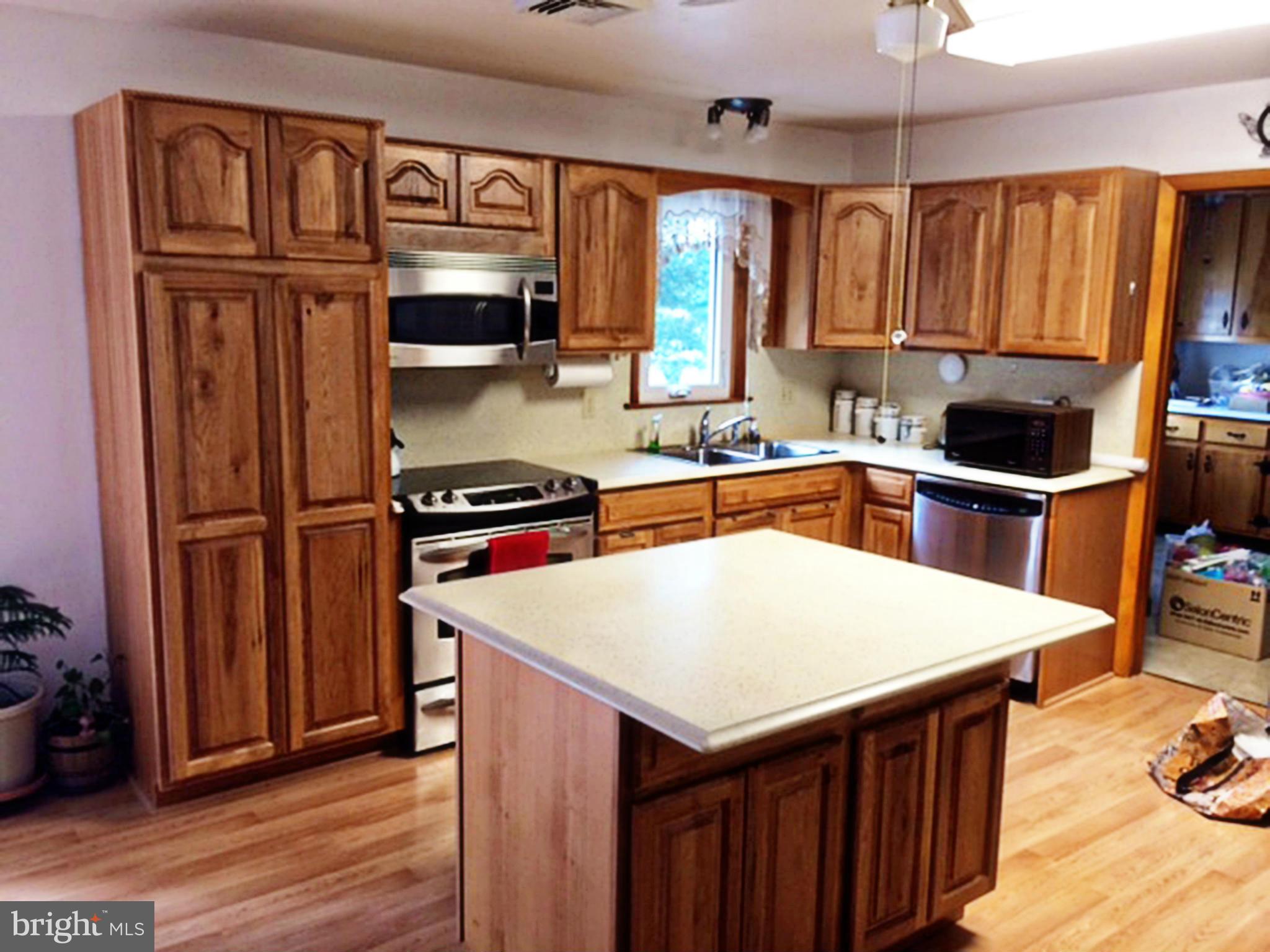 2256 Old Washington Road Westminster, MD 21157 - Photo 2 of 9 a kitchen with granite countertop a refrigerator stove top oven and sink