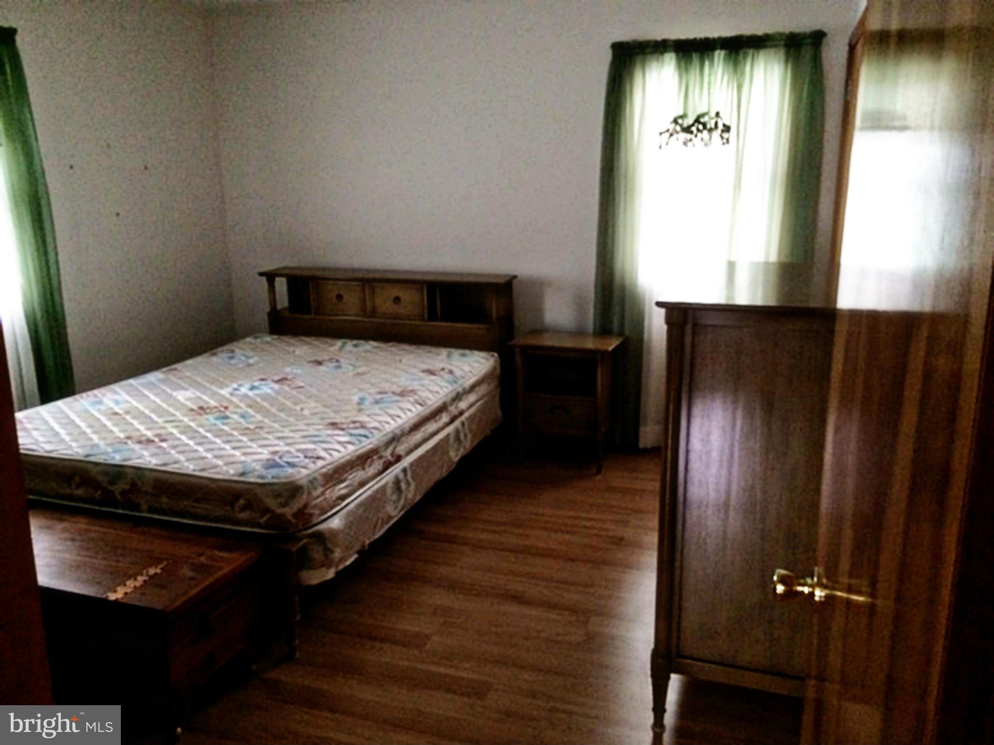 2256 Old Washington Road Westminster, MD 21157 - Photo 4 of 9 a bedroom with a bed and wooden floor