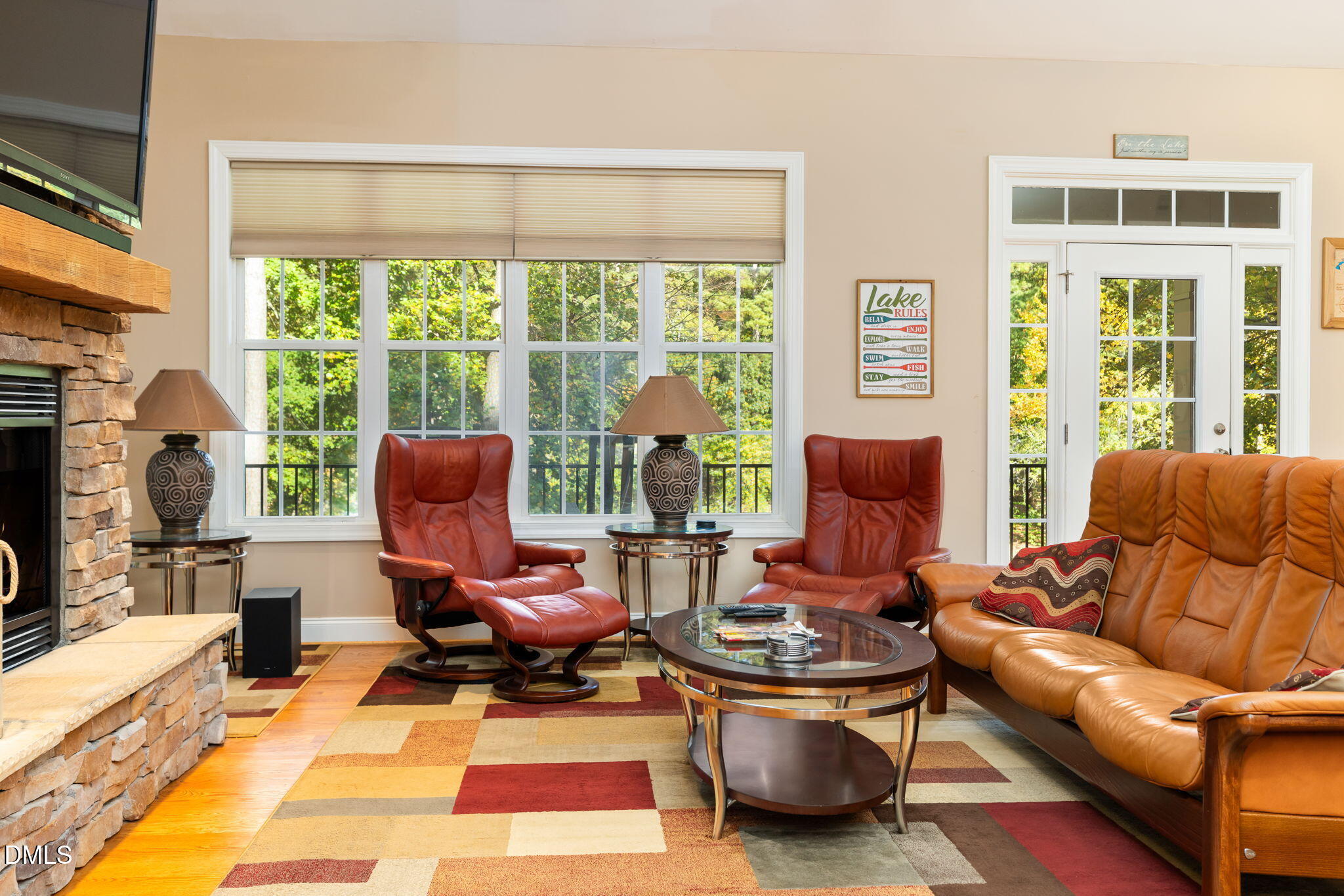 140 Breezewood Road Boydton, VA 23917 - Photo 21 of 87 a living room with furniture a fireplace and large windows