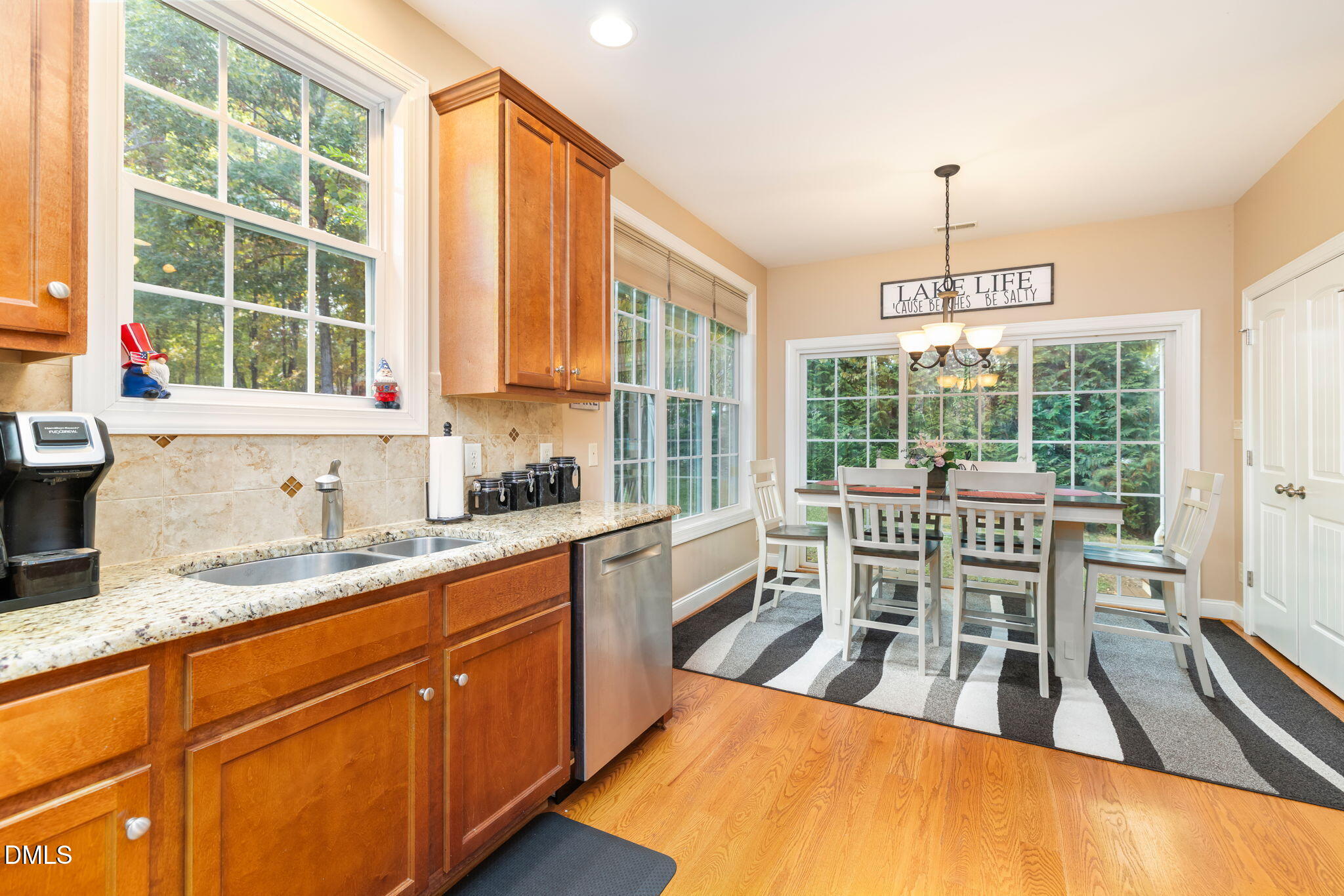 140 Breezewood Road Boydton, VA 23917 - Photo 26 of 87 a dining room with stainless steel appliances granite countertop a stove a sink a dining table and chairs with wooden floor