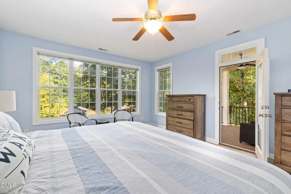 a bedroom with a bed and a large window
