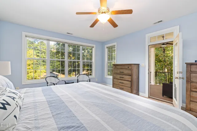 a bedroom with a bed and a large window