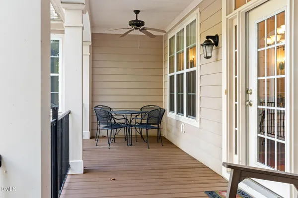 a front view of a house with swimming pool and porch with furniture