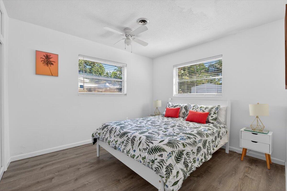 110 Northeast 30th Street Pompano Beach, FL 33064 - Photo 13 of 31 a bedroom with a bed and wooden floor