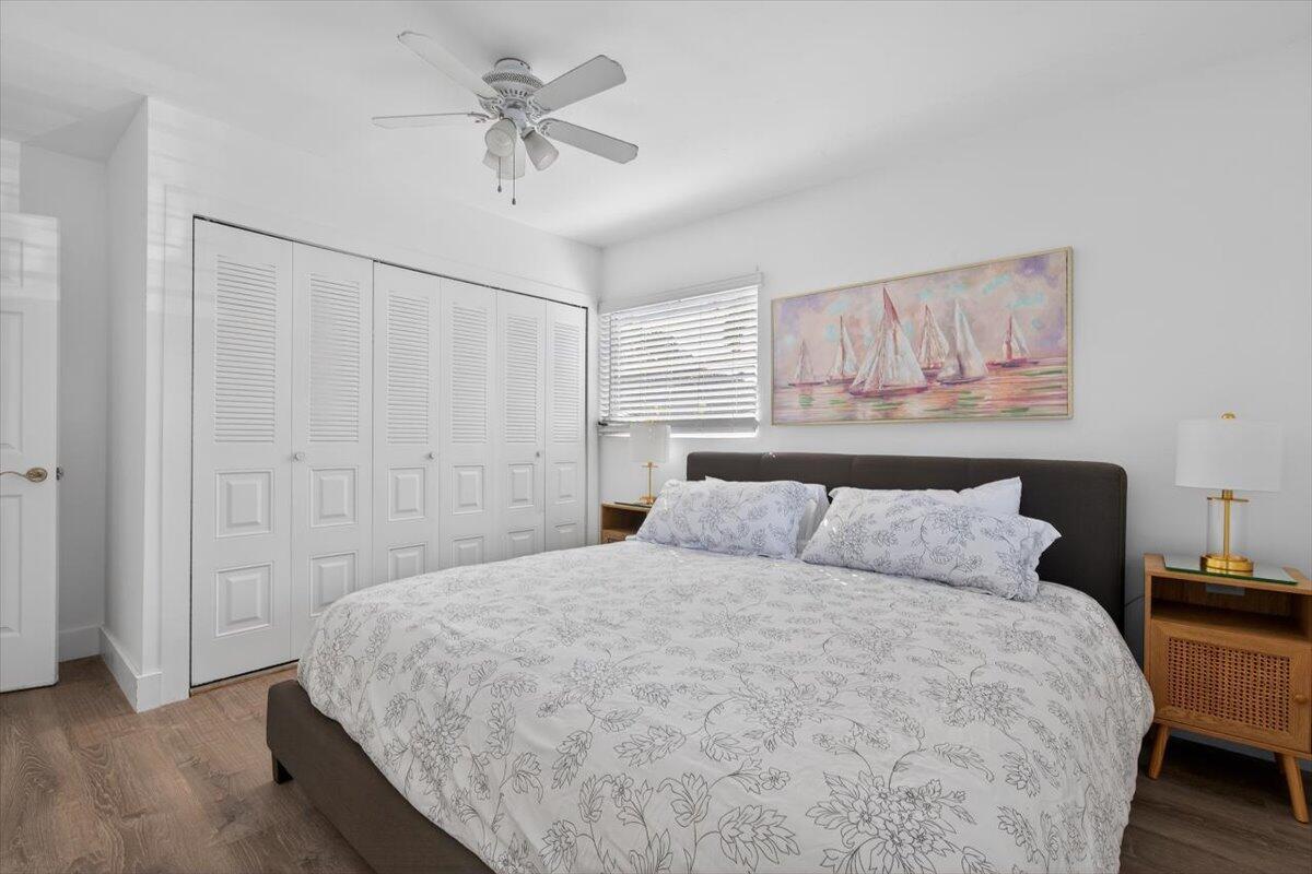 110 Northeast 30th Street Pompano Beach, FL 33064 - Photo 18 of 31 a bedroom with a bed and a ceiling fan