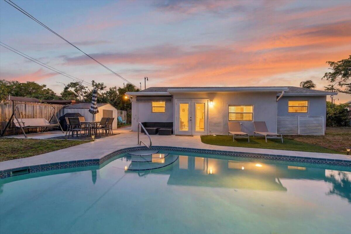 110 Northeast 30th Street Pompano Beach, FL 33064 - Photo 26 of 31 a swimming pool with outdoor seating and yard