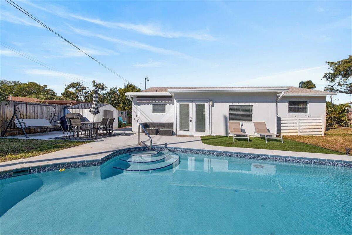 110 Northeast 30th Street Pompano Beach, FL 33064 - Photo 27 of 31 a view of a house with swimming pool and porch with furniture